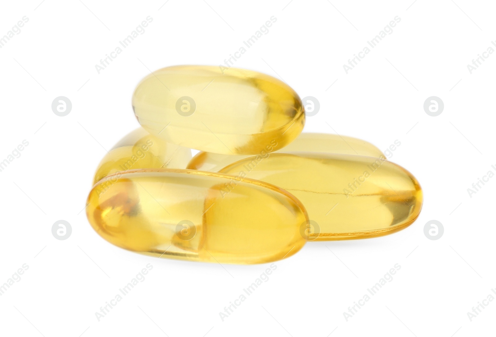 Photo of Many yellow vitamin capsules isolated on white