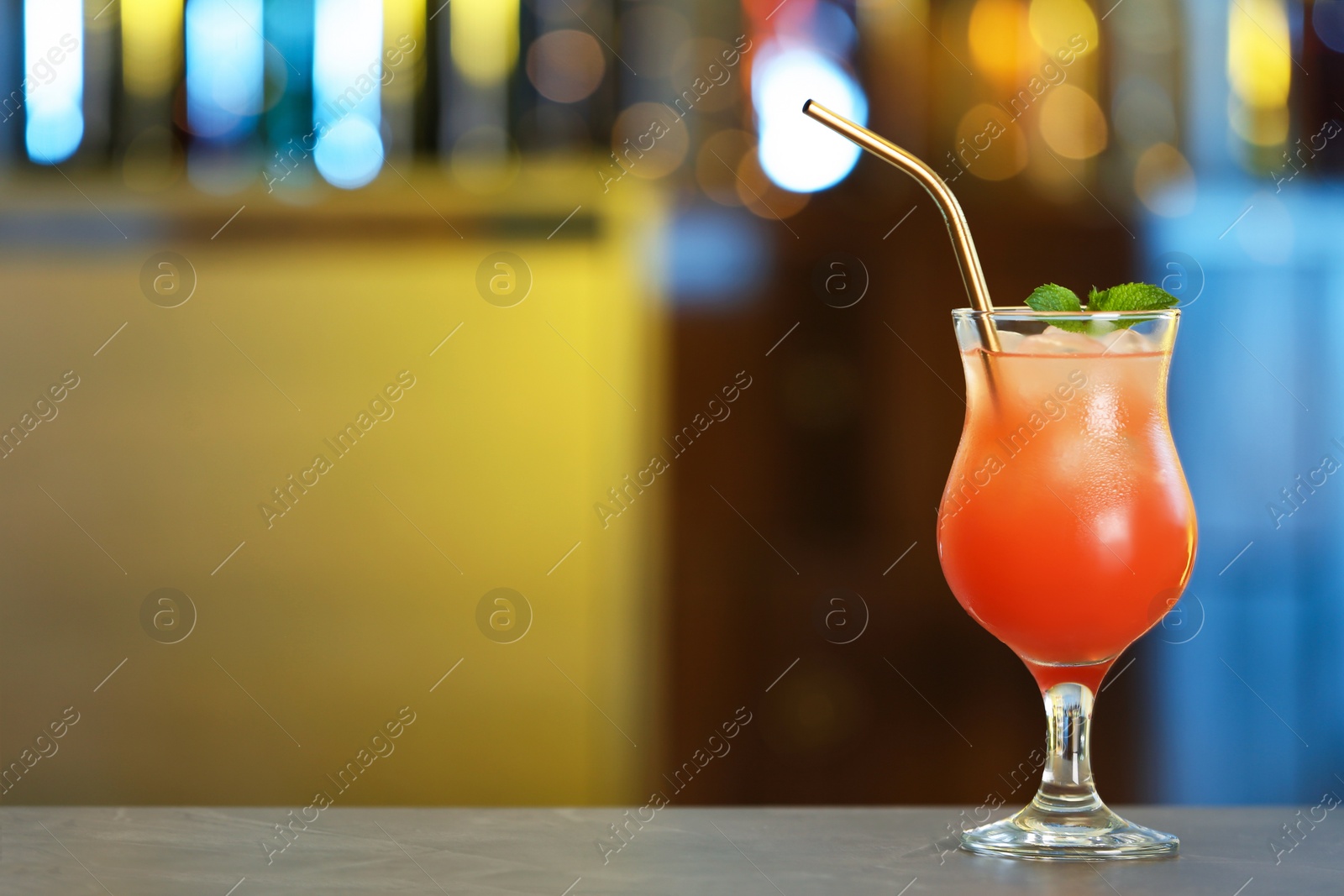 Photo of Fresh alcoholic cocktail with mint on bar counter, space for text