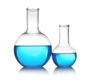 Photo of Flasks with blue liquid on table against white background. Laboratory analysis