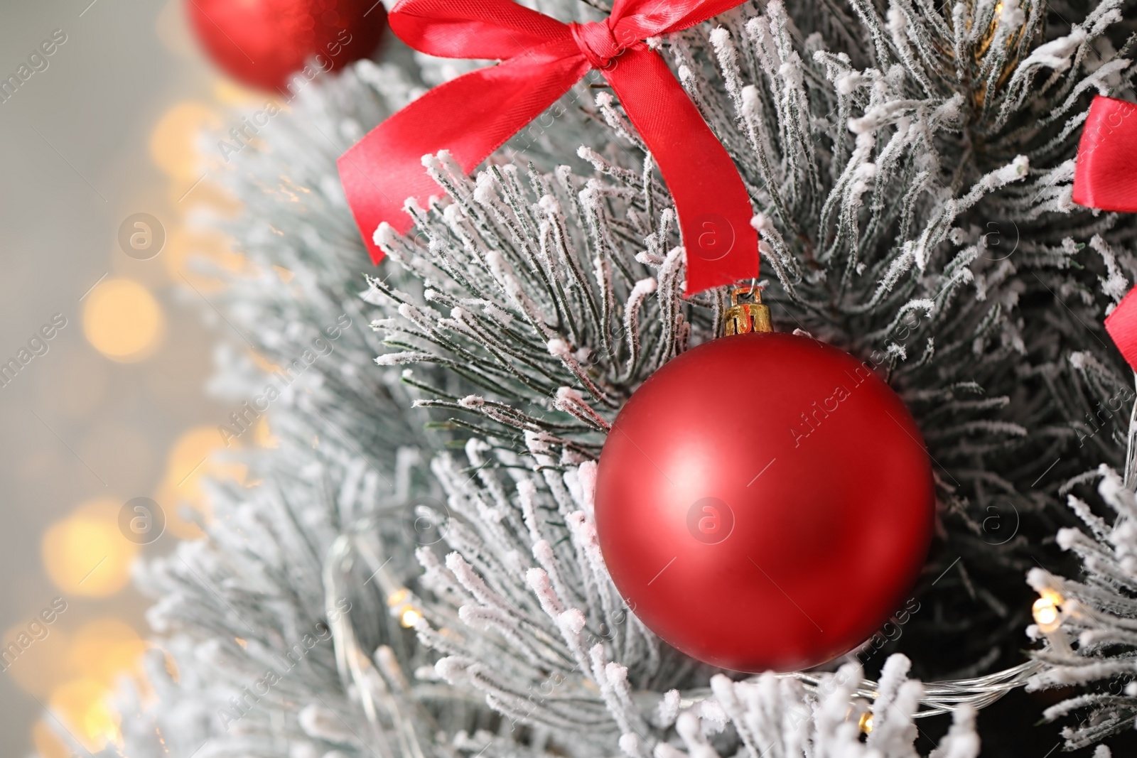 Photo of Beautiful Christmas tree with decor against blurred lights on background