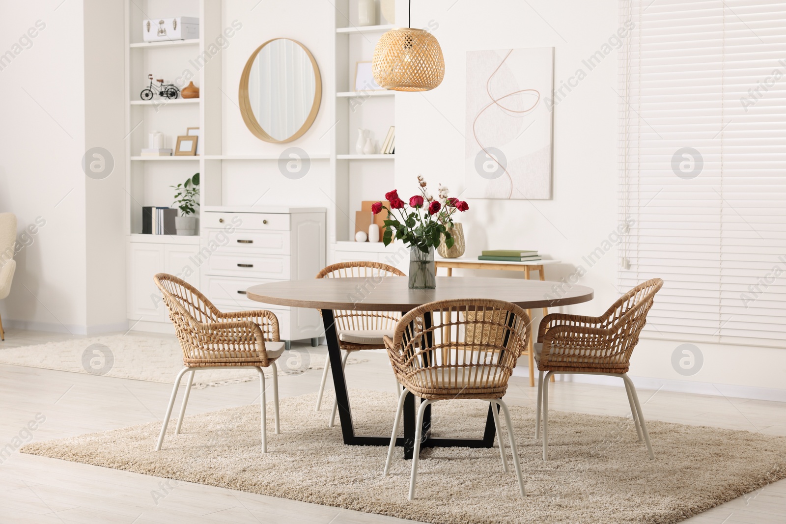 Photo of Stylish dining room interior with table and chairs