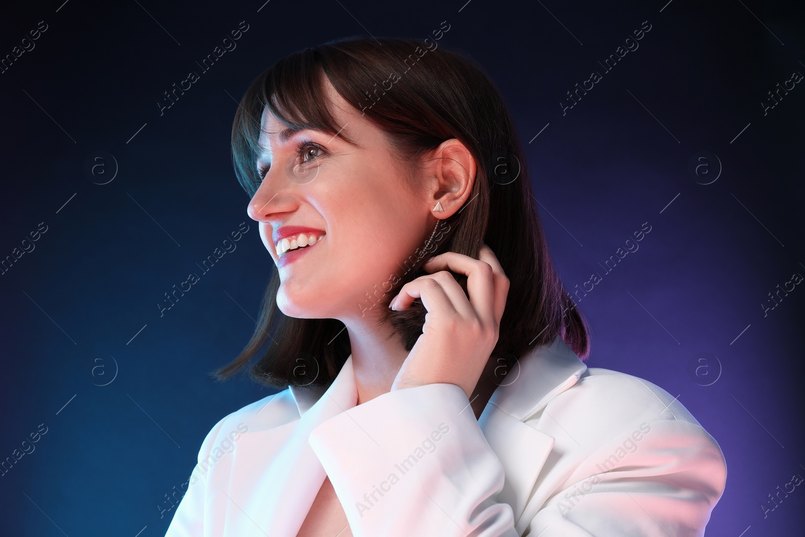 Photo of Portrait of happy woman on dark background