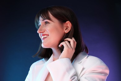 Portrait of happy woman on dark background