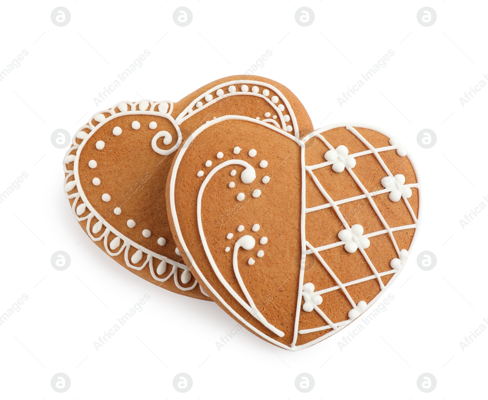 Photo of Gingerbread hearts decorated with icing on white background, above view