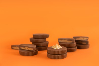 Photo of Sweet peanut butter cups on orange background