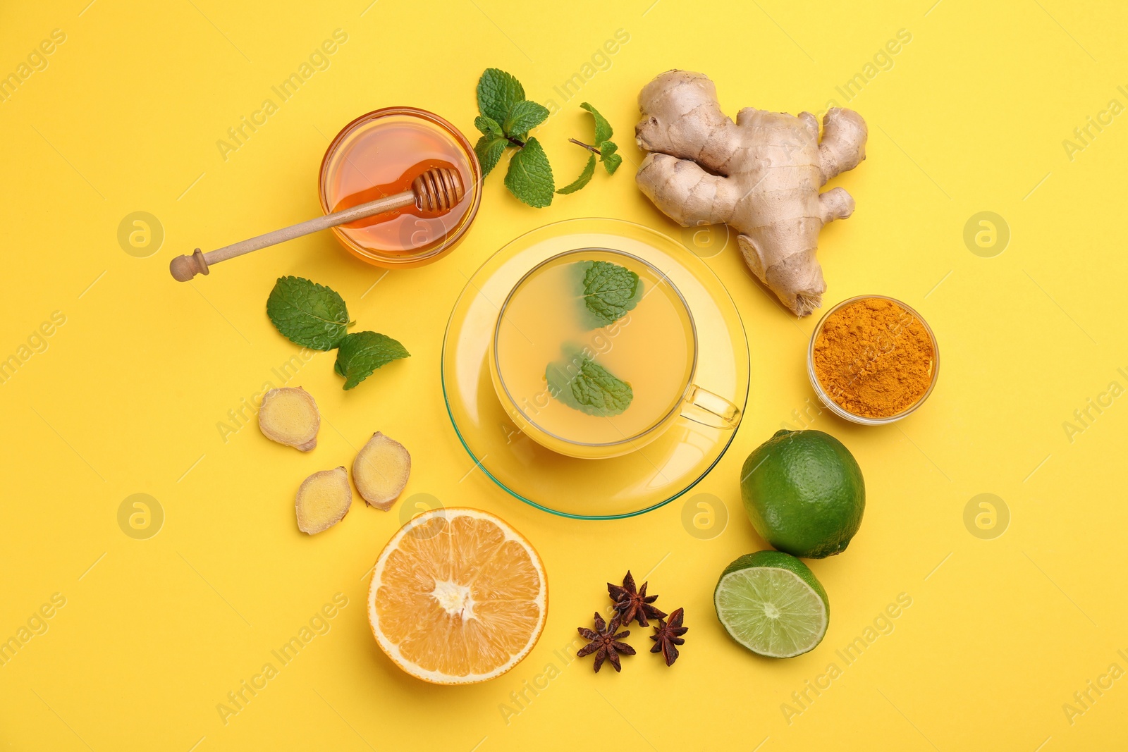 Photo of Flat lay composition with immunity boosting drink and ingredients on yellow background