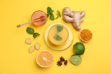 Photo of Flat lay composition with immunity boosting drink and ingredients on yellow background