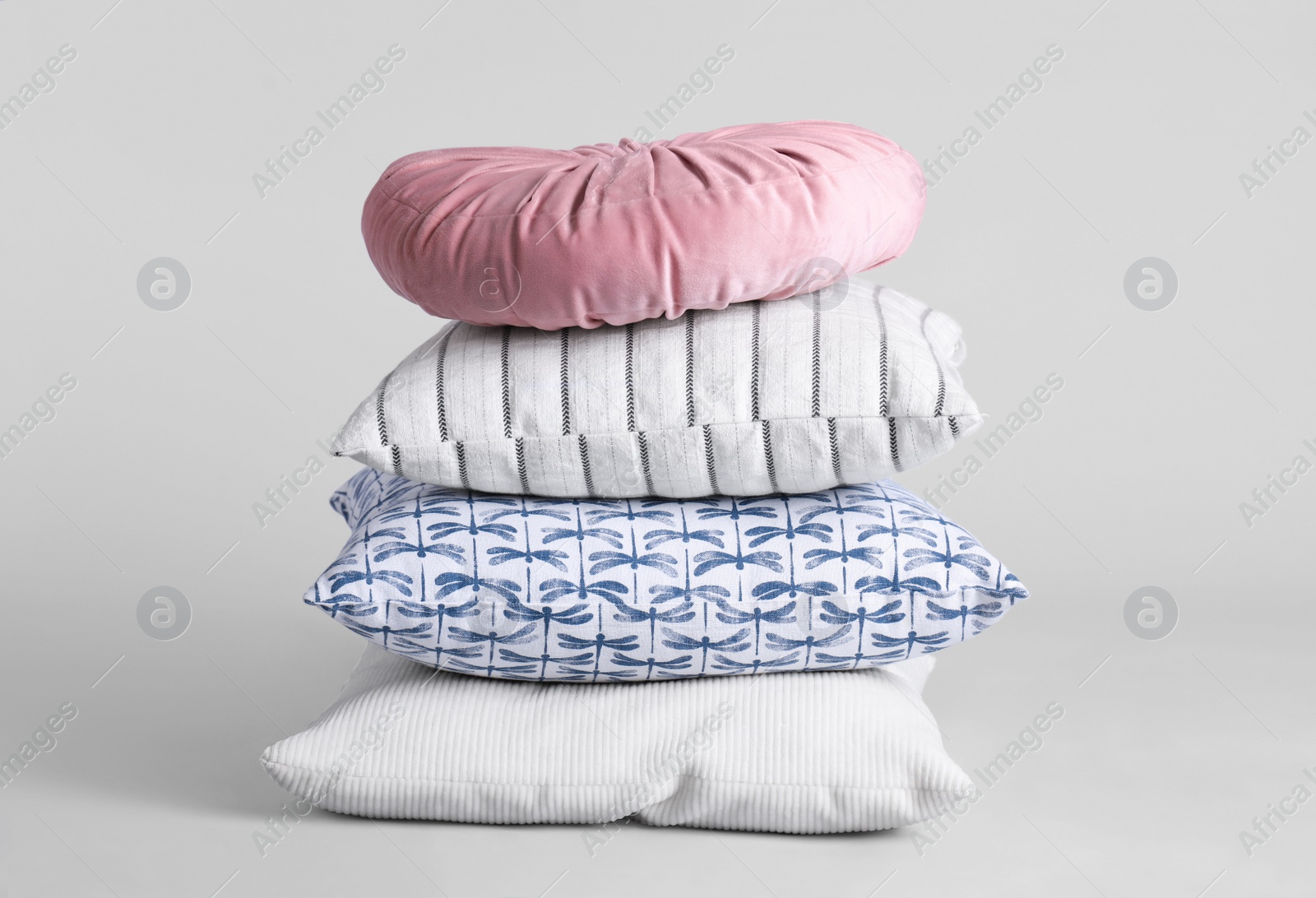 Photo of Stack of stylish soft pillows on grey background
