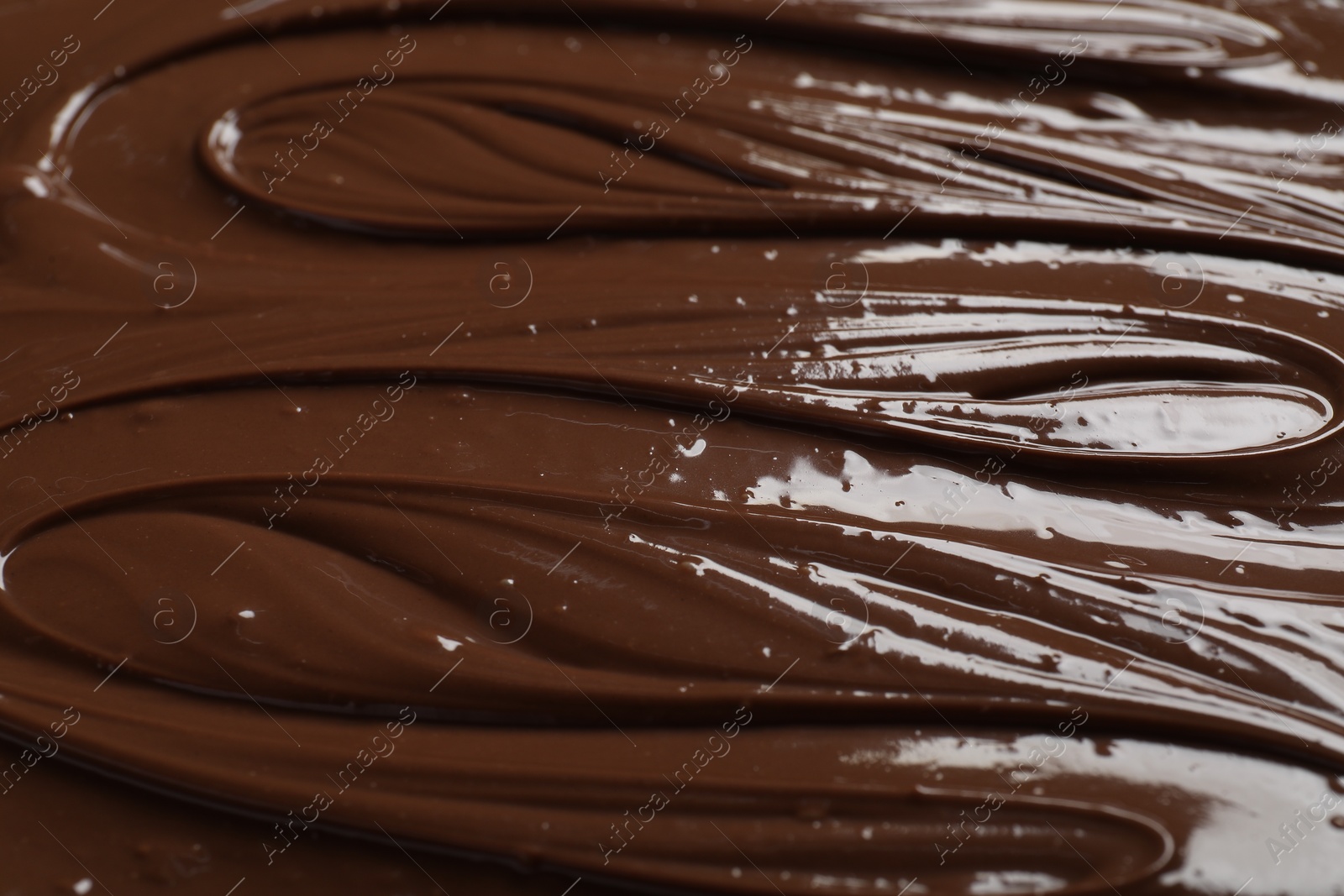 Photo of Tasty milk chocolate paste as background, closeup