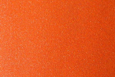 Orange textured surface as background, closeup view