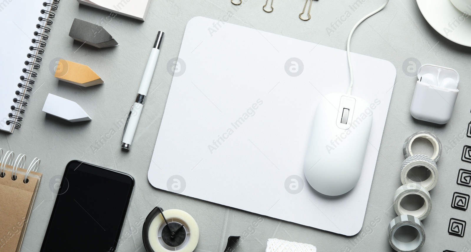 Photo of Flat lay composition with wired computer mouse and stationery on light grey table