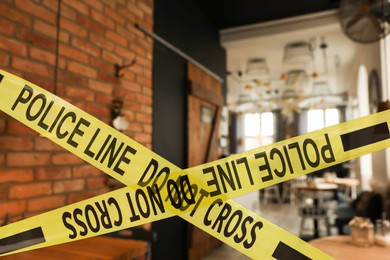 Yellow crime scene tape in empty restaurant