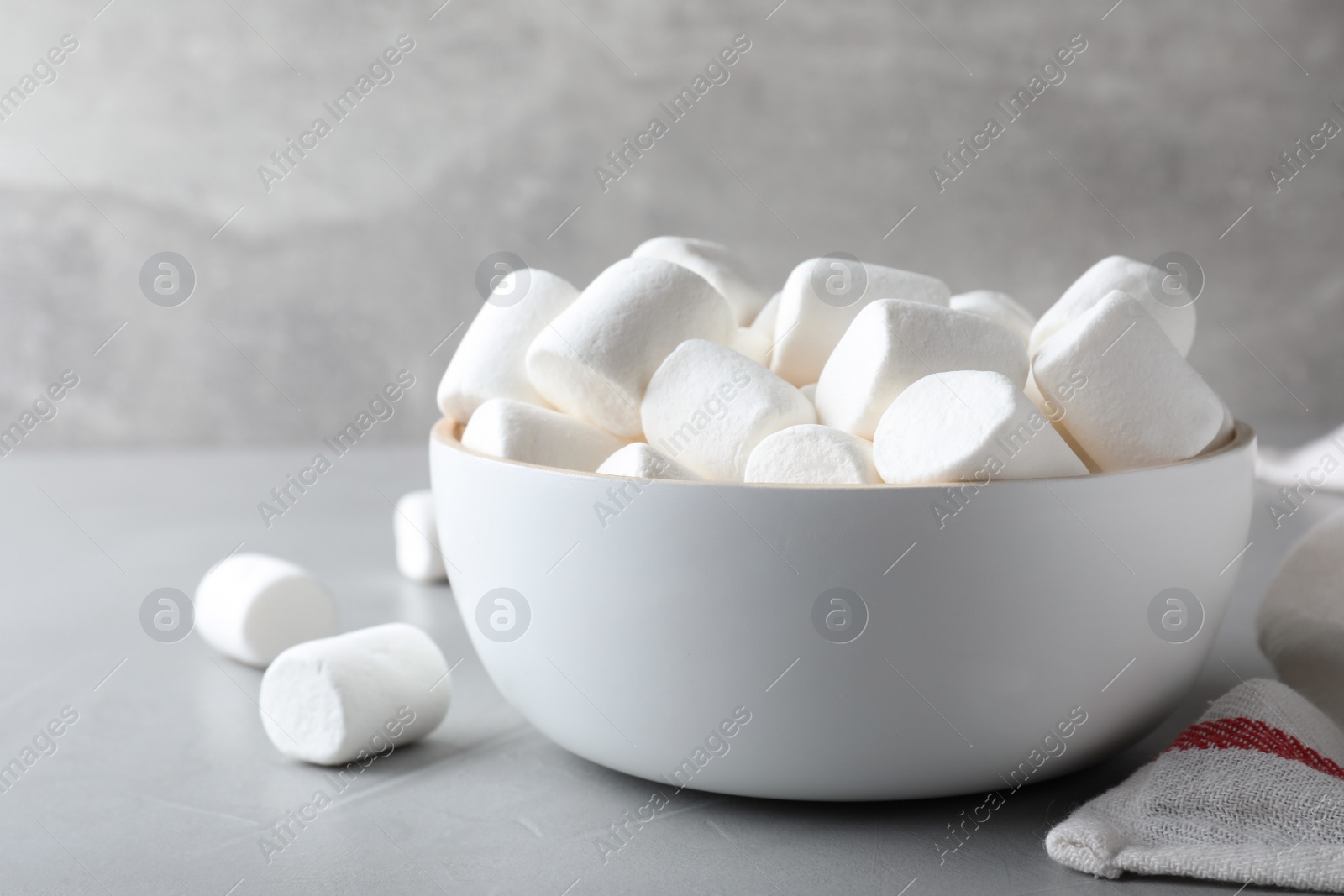 Photo of Delicious puffy marshmallows on grey table, closeup