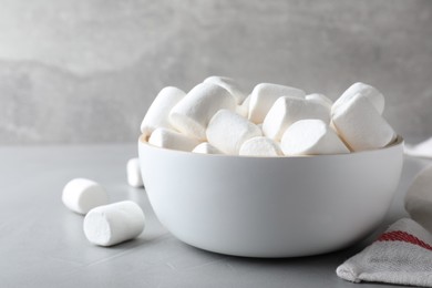 Photo of Delicious puffy marshmallows on grey table, closeup
