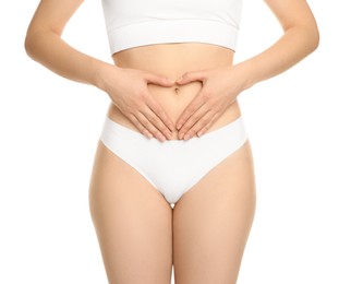 Photo of Gynecology. Woman in underwear making heart with her hands on white background, closeup