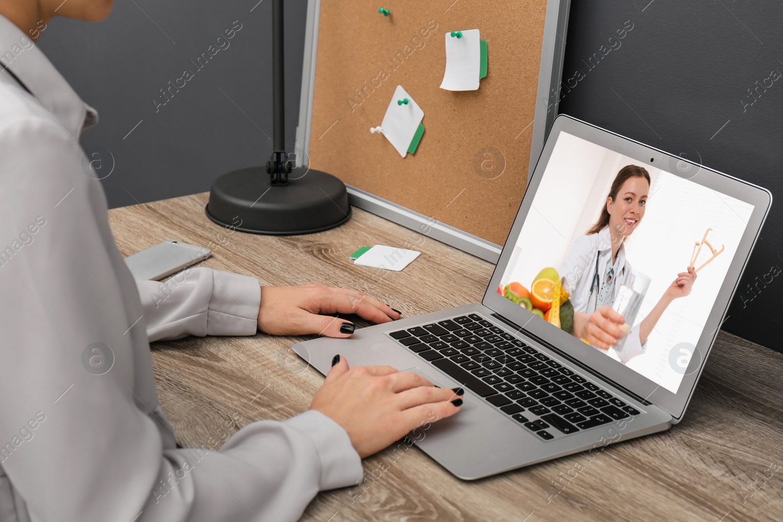 Image of Woman using laptop for online consultation with nutritionist via video chat, closeup