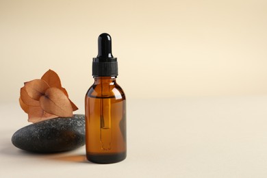 Composition with bottle of cosmetic serum on beige background. Space for text