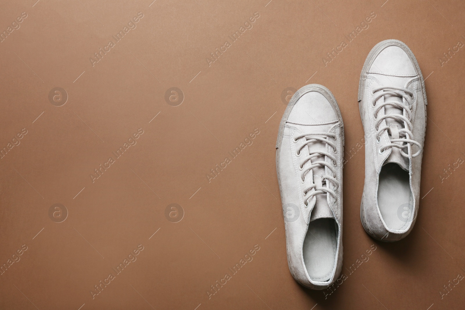 Photo of Stylish sneakers on color background, top view with space for text