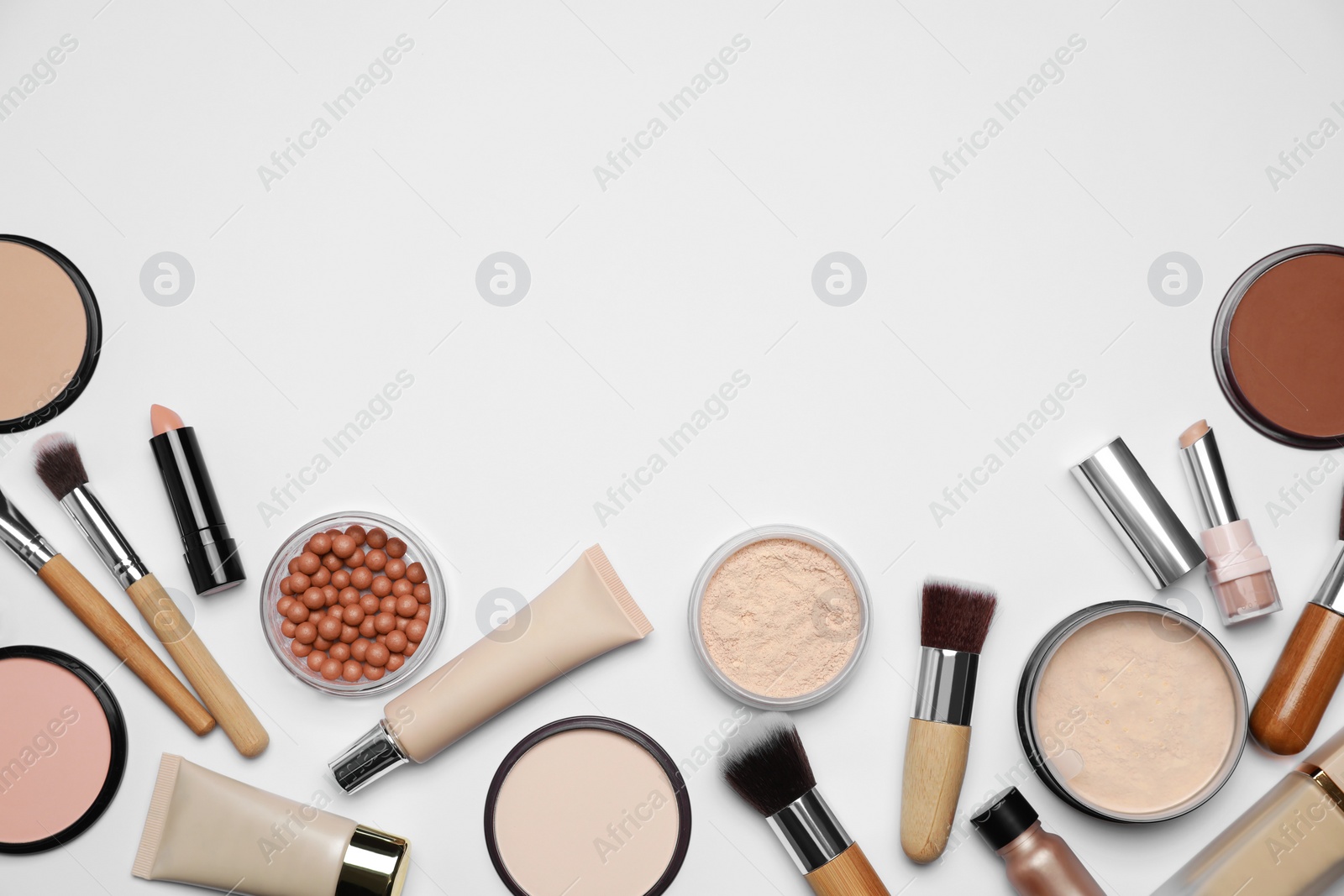 Photo of Face powders and other makeup products on white background, flat lay. Space for text