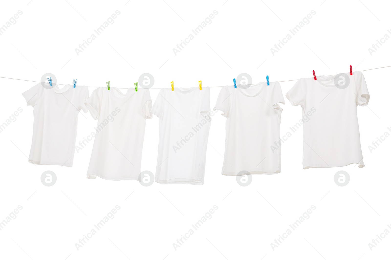 Photo of Many t-shirts drying on washing line isolated on white