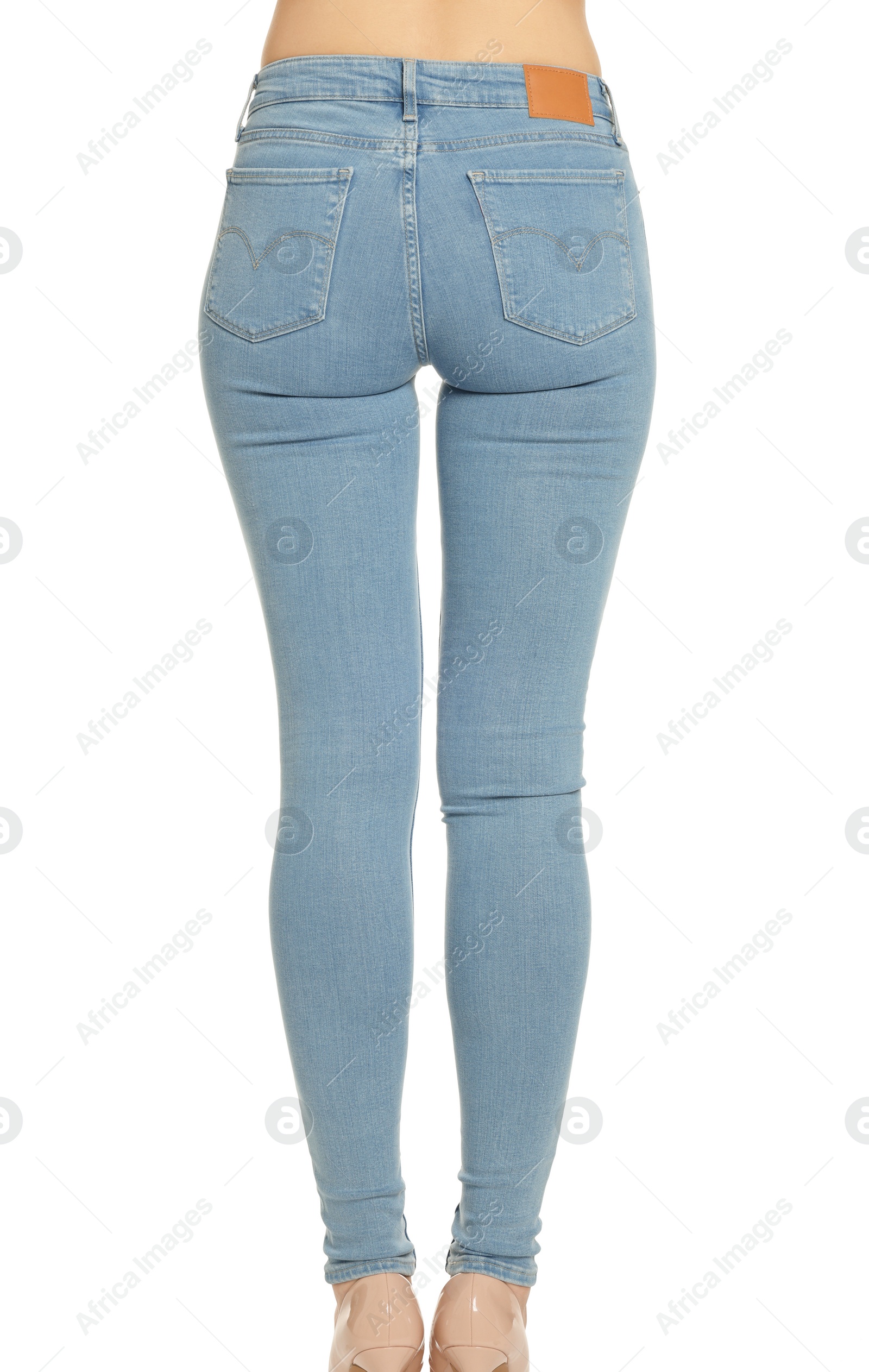 Photo of Woman wearing stylish light blue jeans on white background, closeup