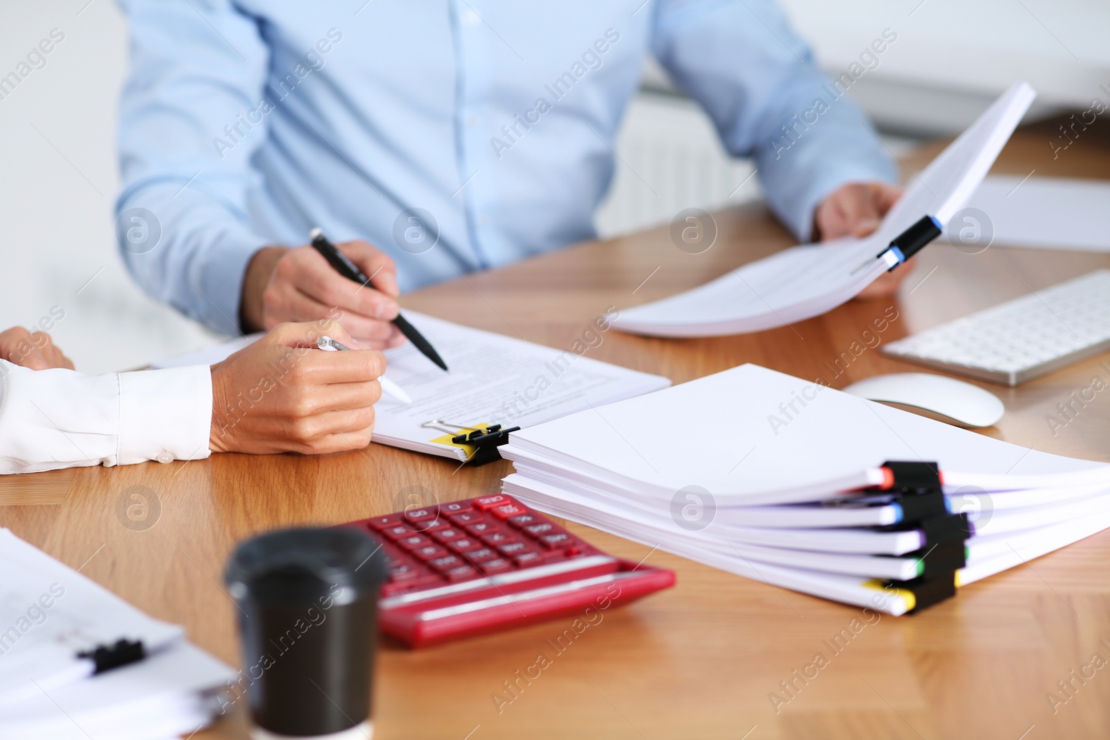 Photo of Businesspeople working with documents at table in office, closeup