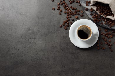 Photo of Cup of aromatic hot coffee and beans on grey table, flat lay. Space for text