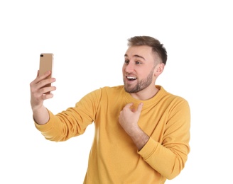 Photo of Young man using video chat on smartphone against white background