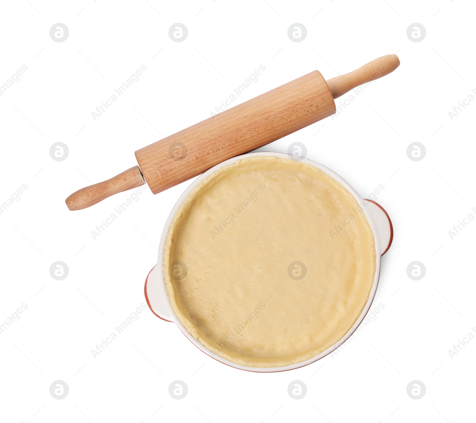 Photo of Pie tin with fresh dough and rolling pin isolated on white, top view. Making quiche