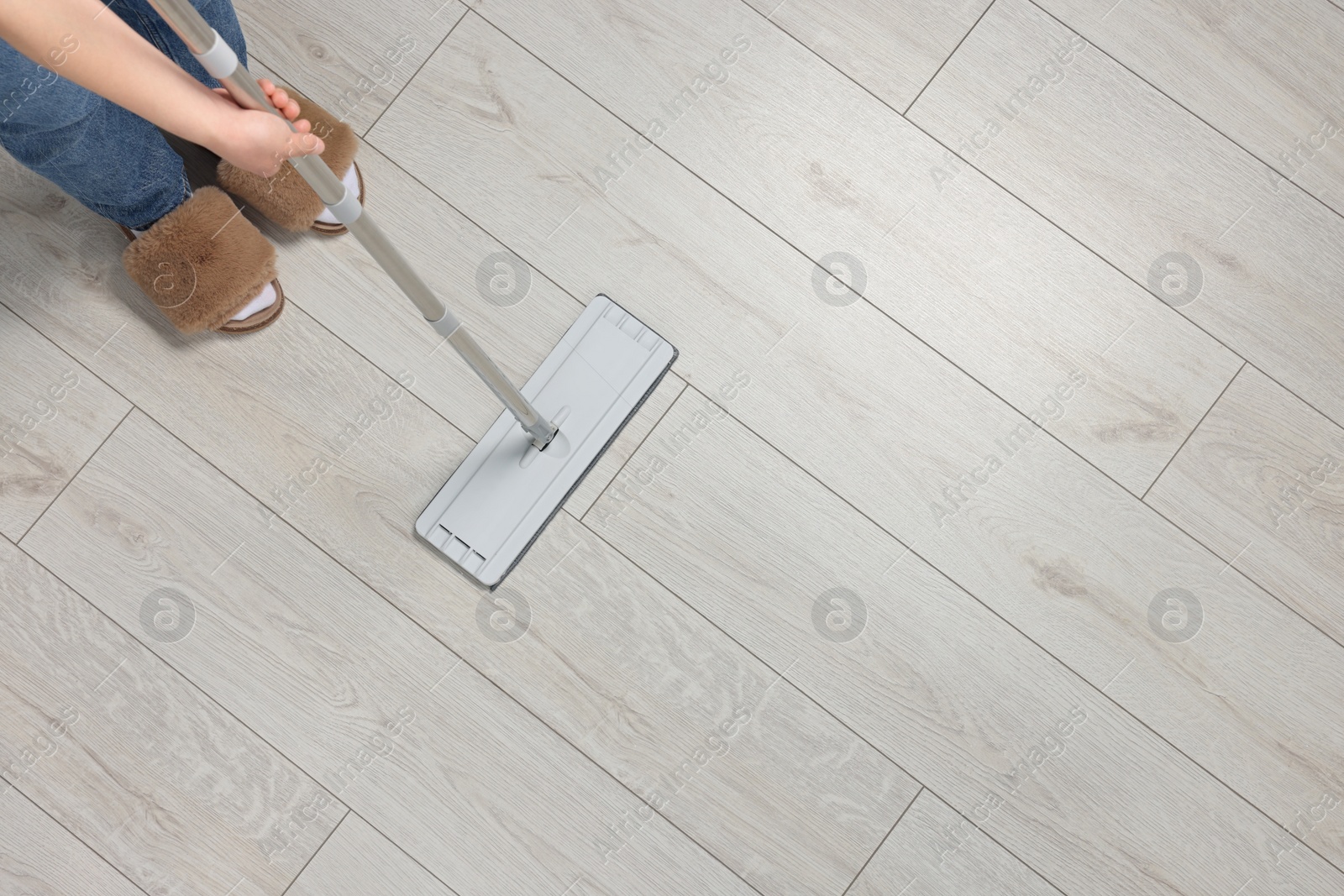 Photo of Woman mopping wooden floor, top view. Space for text