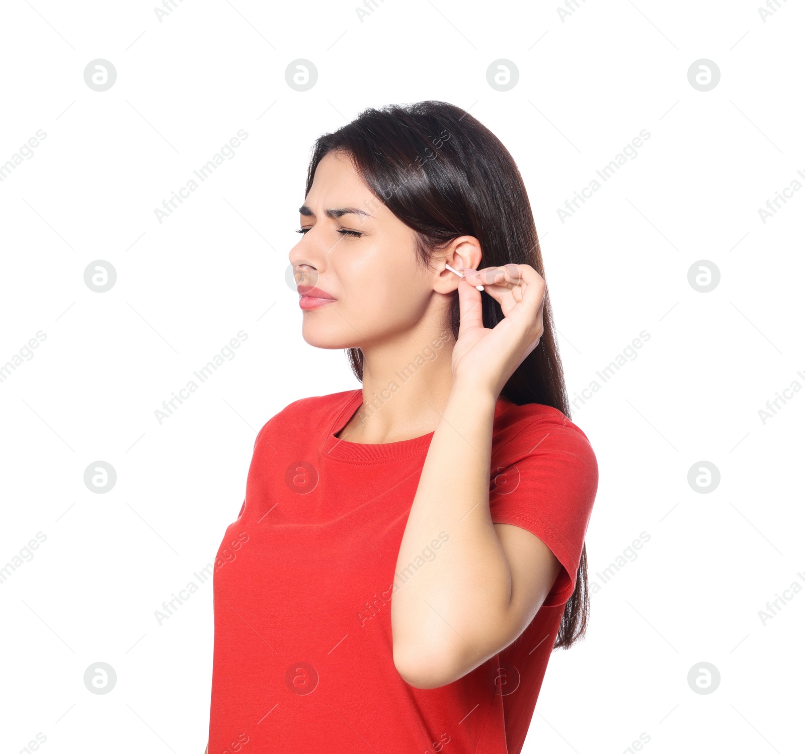 Photo of Young woman cleaning ear with cotton swab on white background