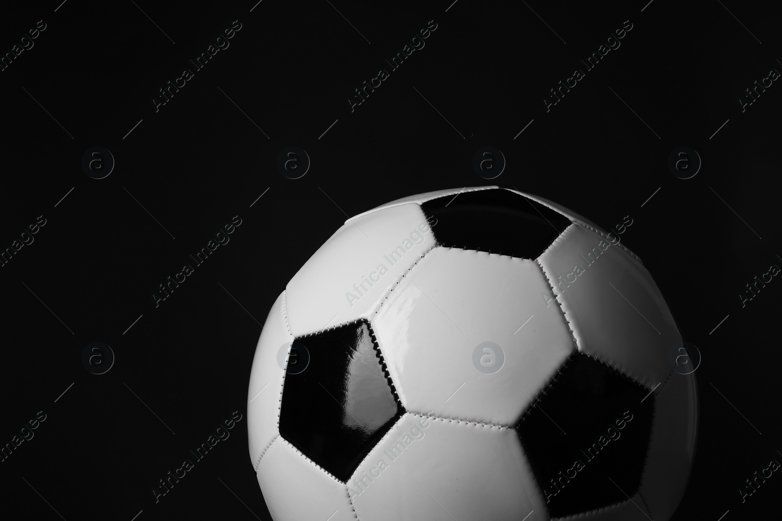 Photo of One soccer ball on black background. Sports equipment