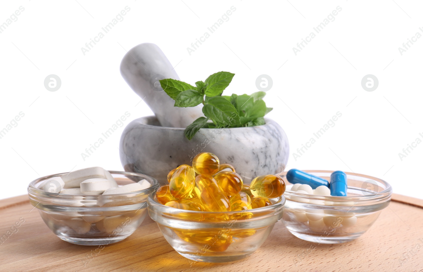 Photo of Mortar with fresh mint and pills on white background