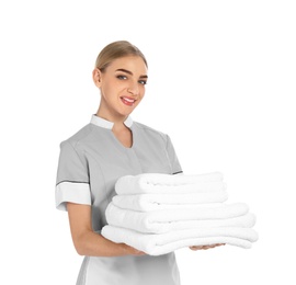 Young chambermaid with stack of clean towels on white background