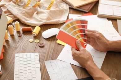 Photo of Male designer working at wooden table, closeup