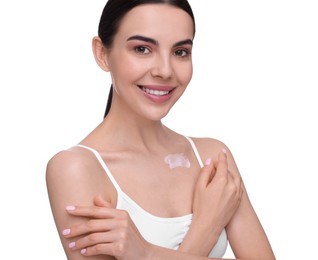 Beautiful woman with smear of body cream on her collarbone against white background