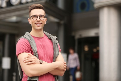 Portrait of attractive young man in stylish outfit outdoors