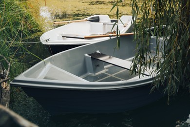 Modern boats with wooden oars on lake