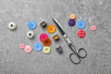 Photo of Composition with threads and sewing accessories on grey background, top view