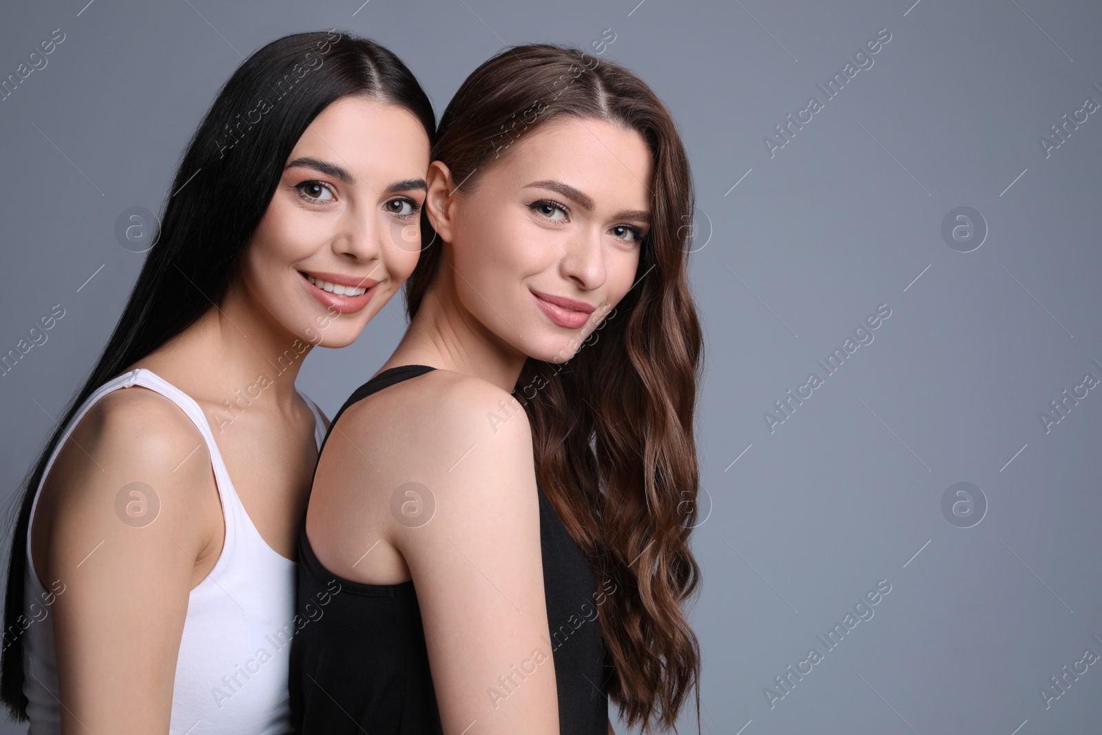 Photo of Portrait of beautiful women on grey background, space for text