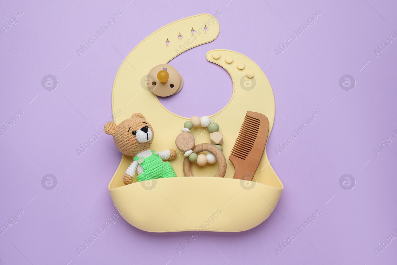 Photo of Baby accessories and bib on background, flat lay