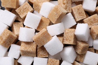 Photo of White and brown sugar cubes as background, top view