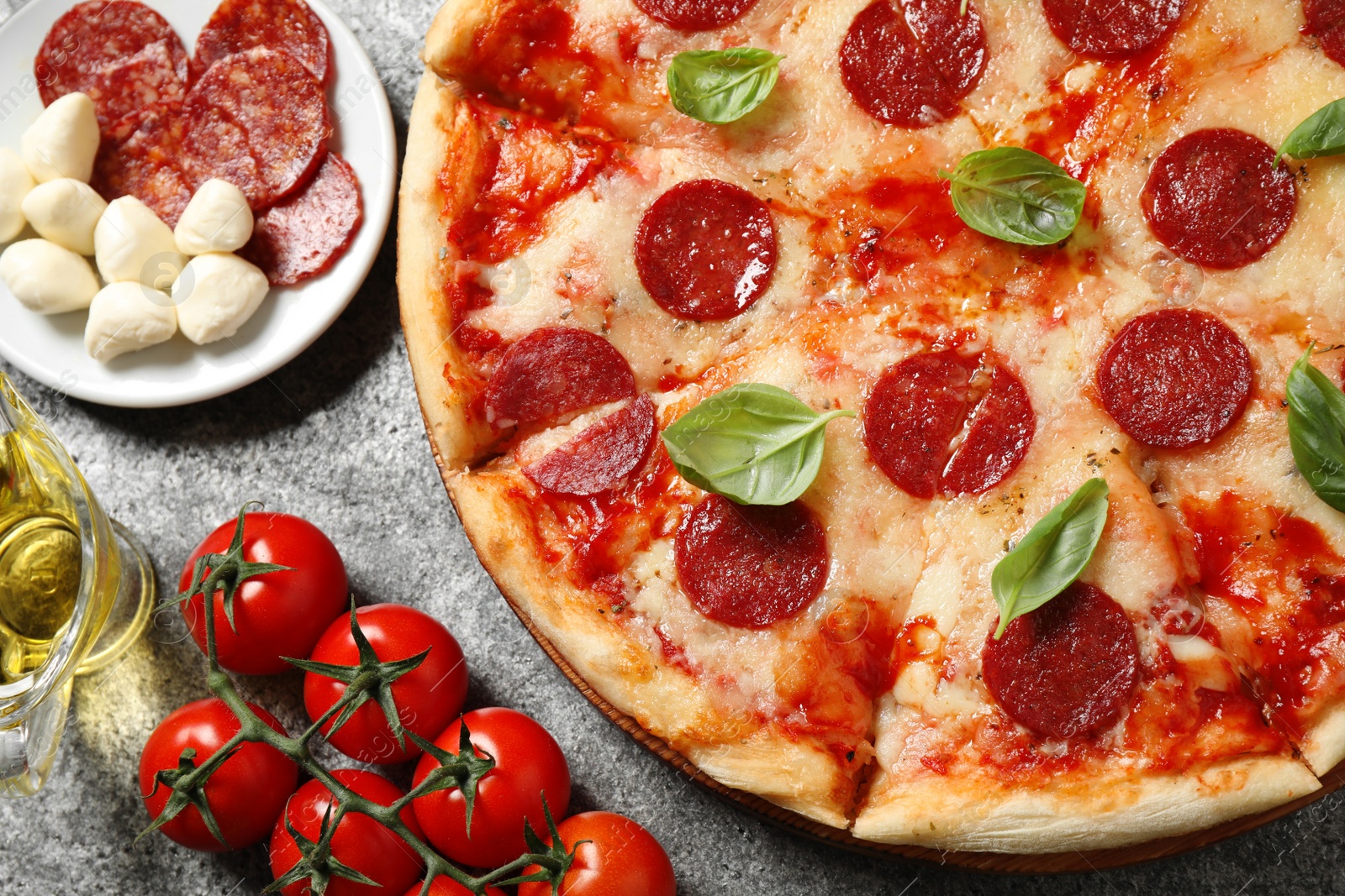 Photo of Flat lay composition with hot pepperoni pizza on grey  table