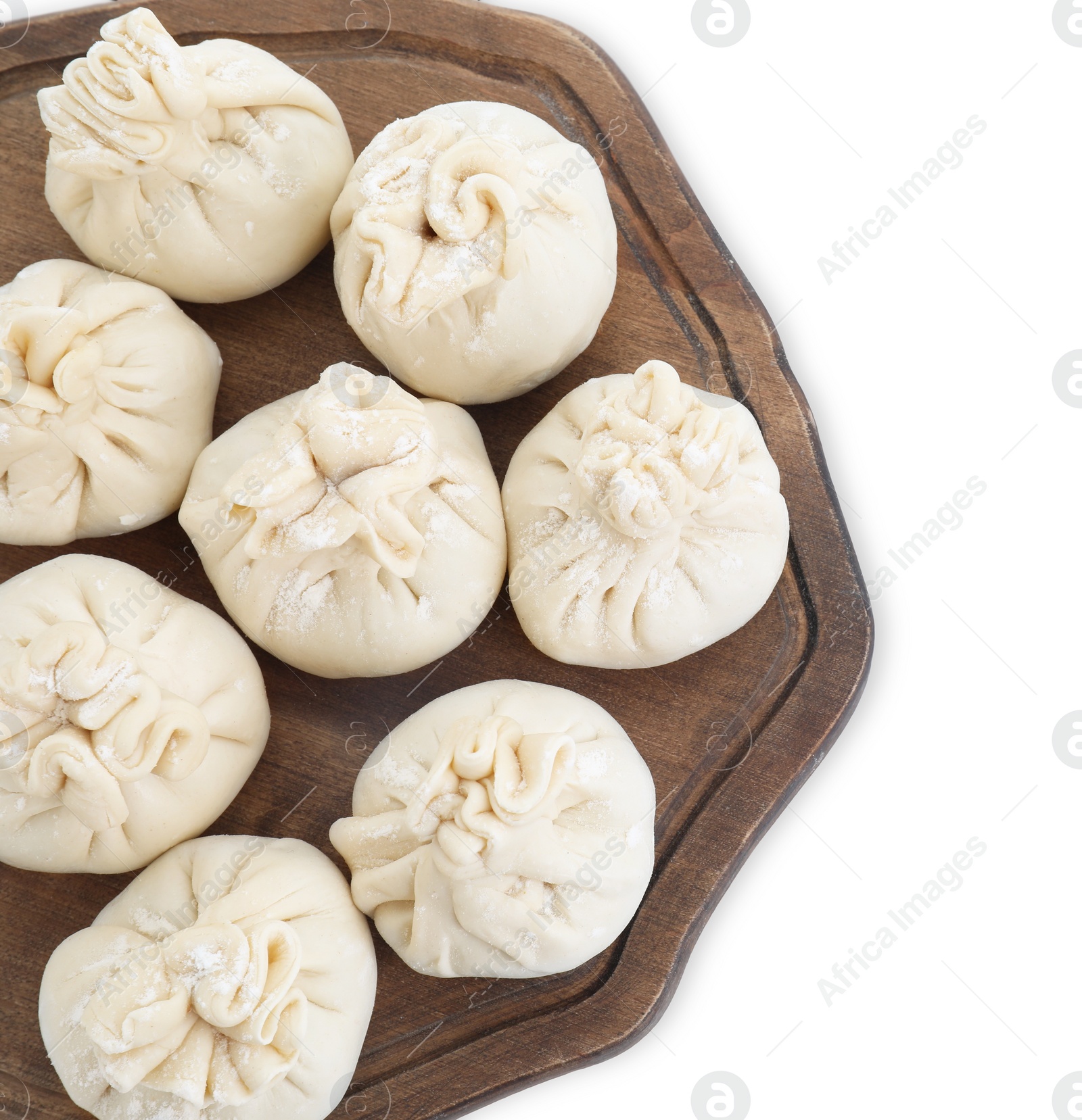 Photo of Board with uncooked khinkali (dumplings) isolated on white, top view. Georgian cuisine