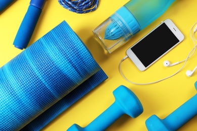 Flat lay composition with fitness gym equipment on color background