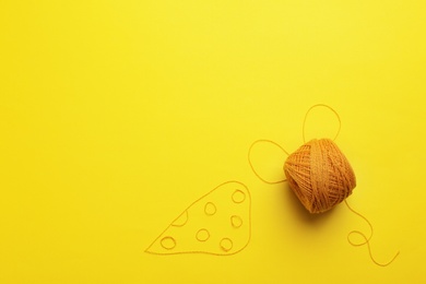 Photo of Mouse and cheese made of knitting threads on color background, top view with space for text. Sewing stuff