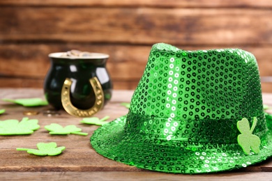 Photo of Leprechaun's hat and St. Patrick's day decor on wooden table