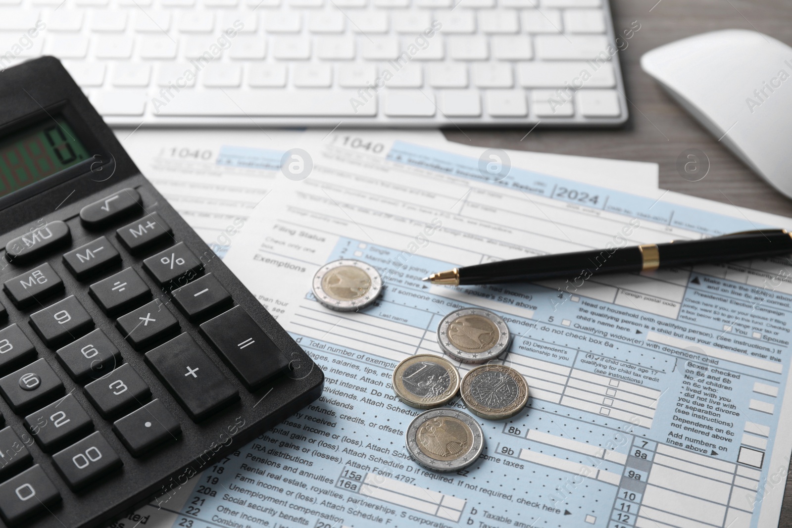 Photo of Tax accounting. Calculator, document, coins, keyboard and pen on table, closeup