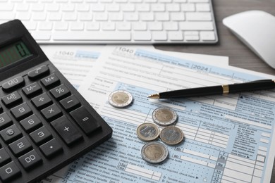 Photo of Tax accounting. Calculator, document, coins, keyboard and pen on table, closeup