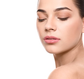 Portrait of young woman with beautiful face and natural makeup on white background, closeup